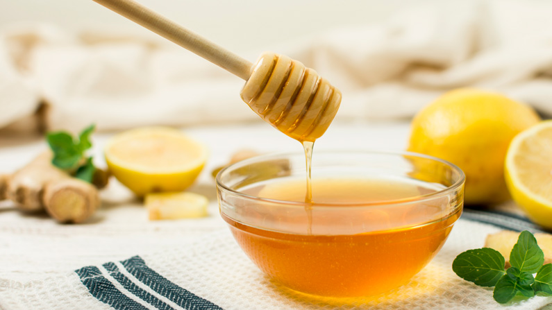 A bowl of honey and lemons